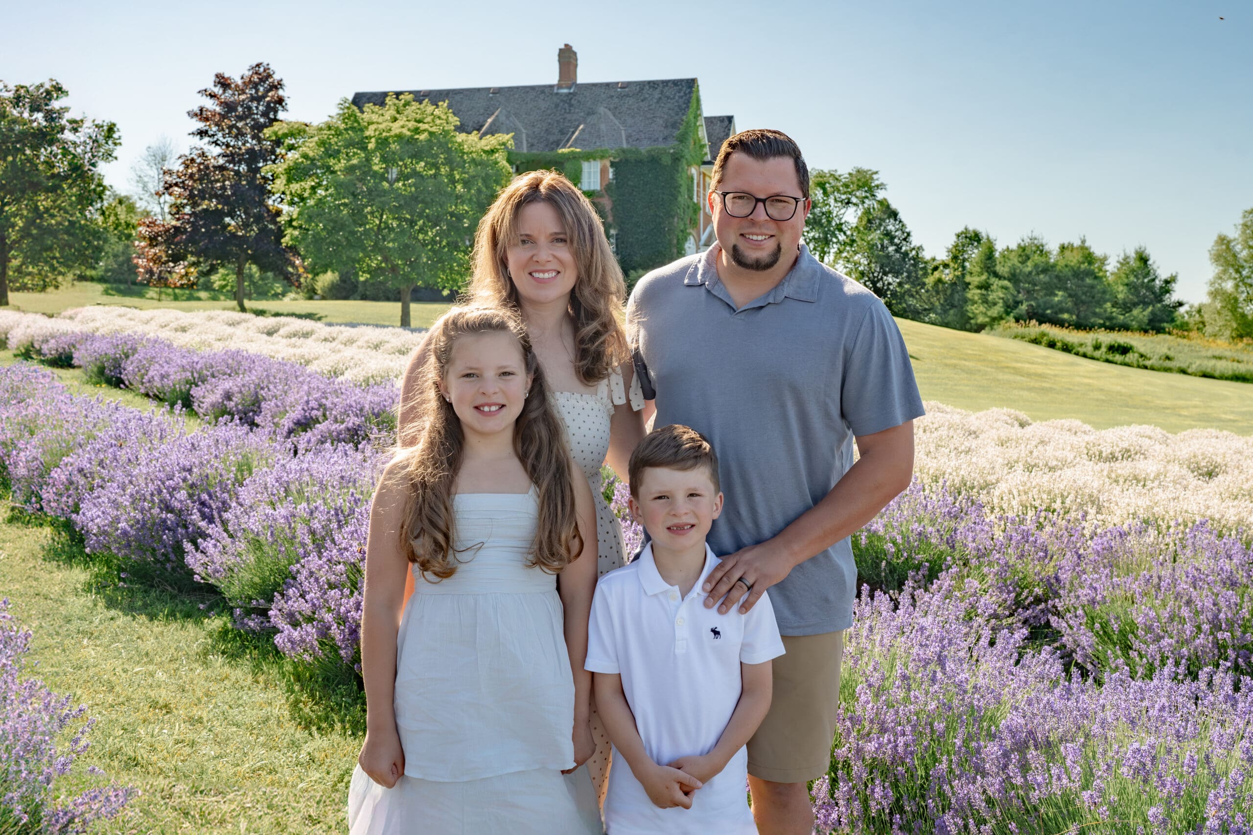 Family standing in lavender field — photographed by Alliston and Barrie maternity, newborn, and family photographer.