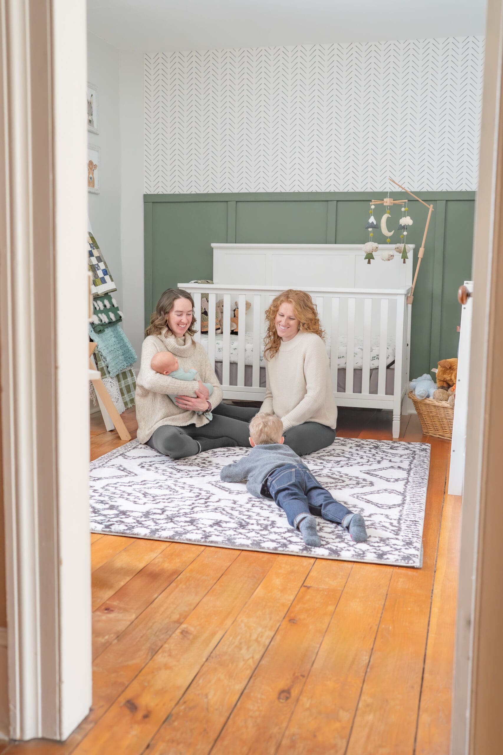 Family sitting in nursery during newborn session  — photographed by Alliston and Barrie maternity, newborn, and family photographer.