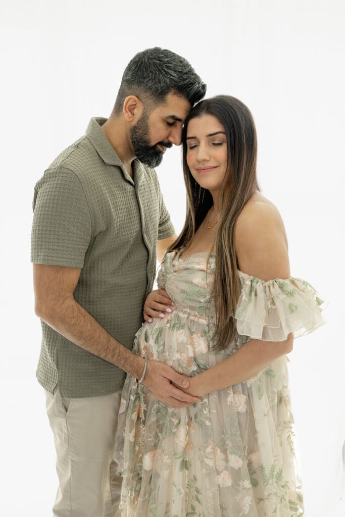 Expecting couple embracing during a soft, natural light maternity session — photographed by Alliston and Barrie maternity, newborn, and family photographer.