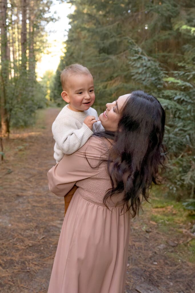 Mom dancing with toddler during family photography session in Bradford