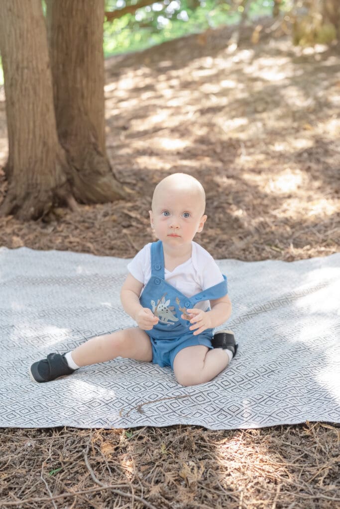 Toddler sitting on blanket during family photography session in Tottenham