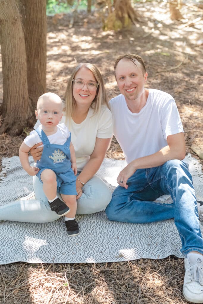 Family sitting on blanket and smiling during family photography session in Tottenham