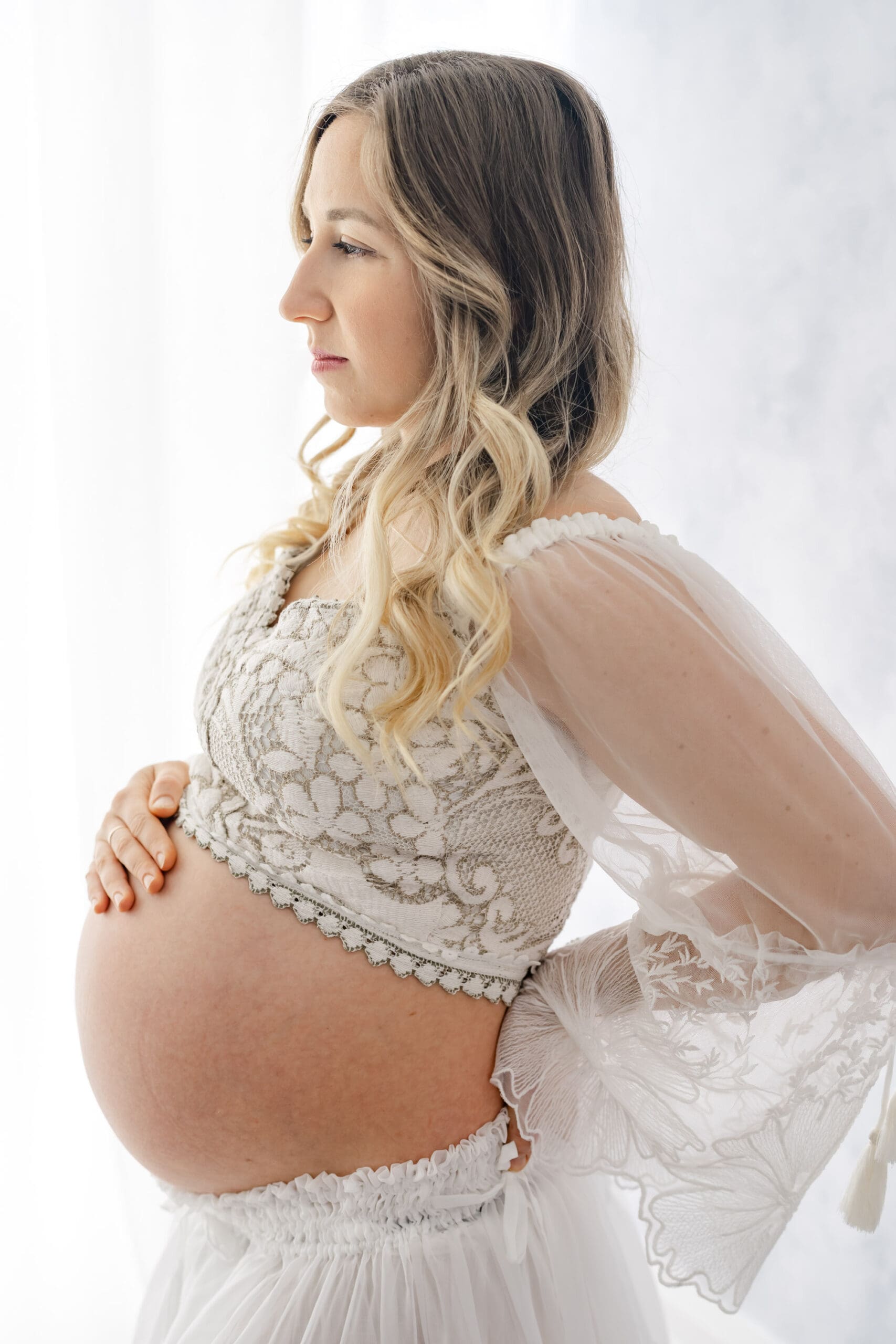 Fine art Barrie maternity session featuring woman holding bump