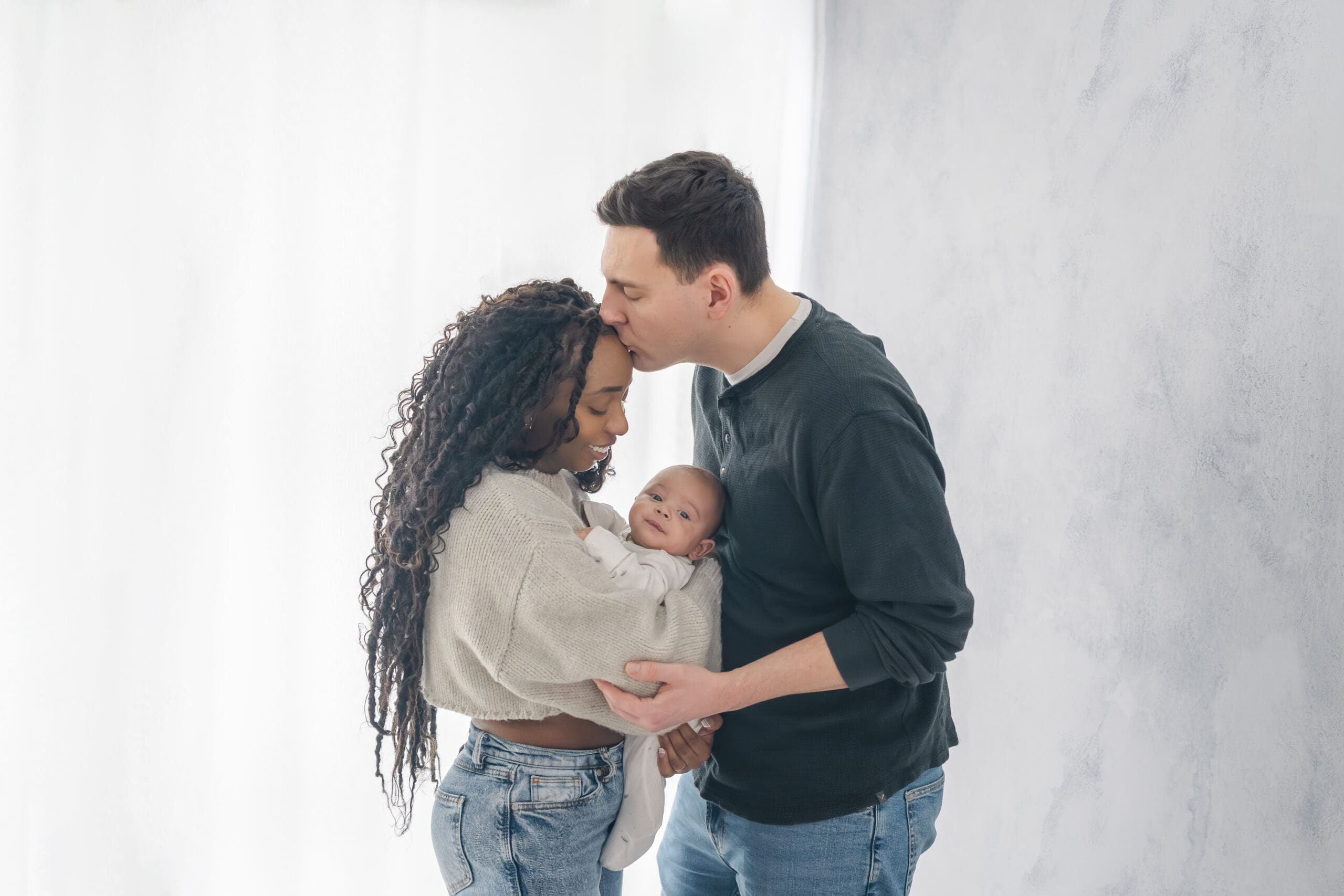 Barrie newborn session with mom and dad holding baby